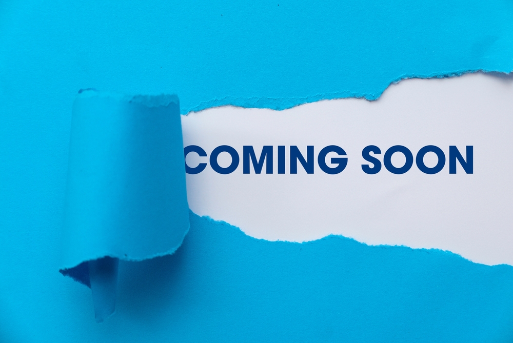 Blue,Torn,Paper,Revealing,The,Word,'coming,Soon'.